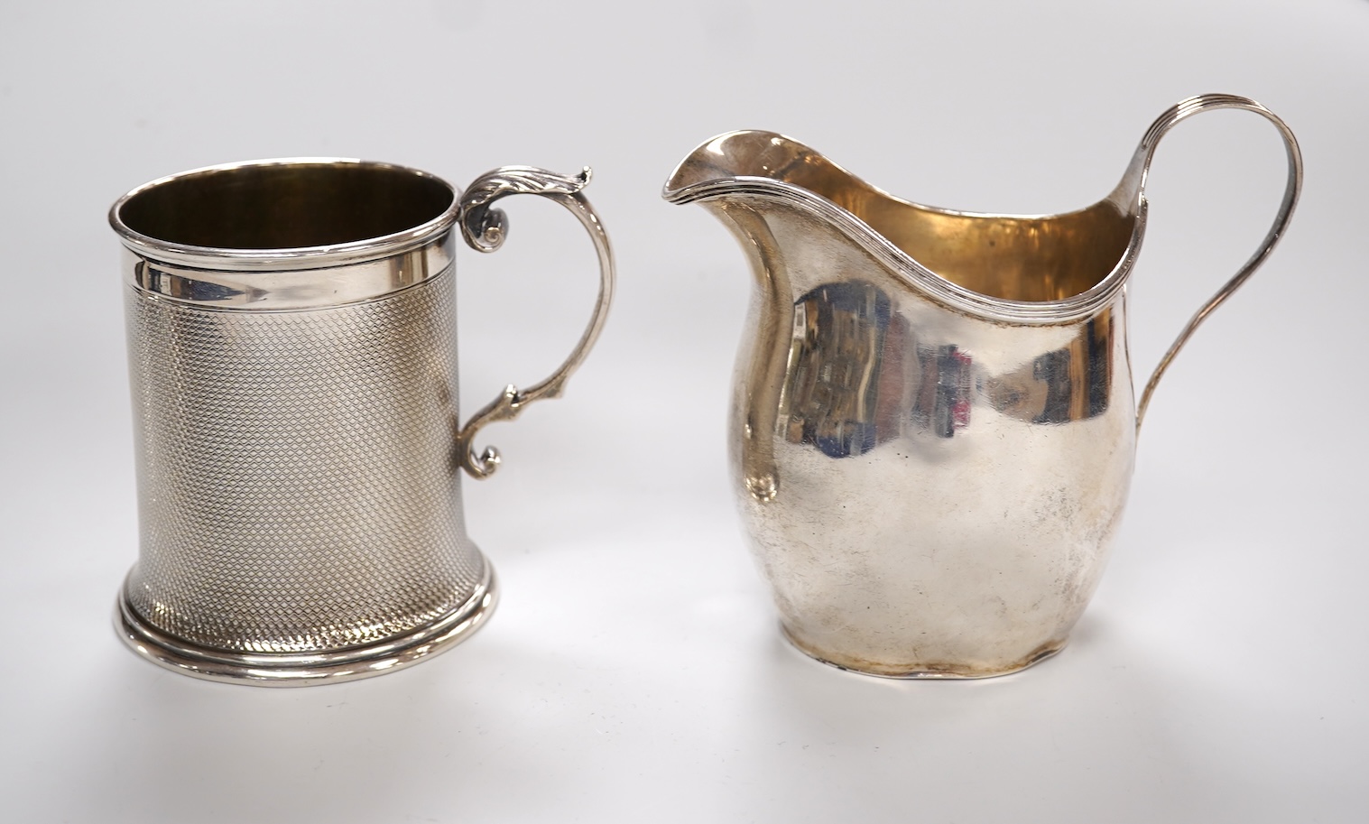 A Victorian engine turned silver christening mug by John Samuel Hunt (Hunt & Roskell), London, 1863, with later engraved inscription to the base, height 89mm, together with a George VI silver cream jug, London, 1947, 12o